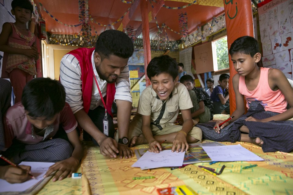 CH1366945 Nur Draws At A Child Friendly Space In A Cox's Bazar Rohingya Refugee Camp With With Nezam, A Lead Facilitator